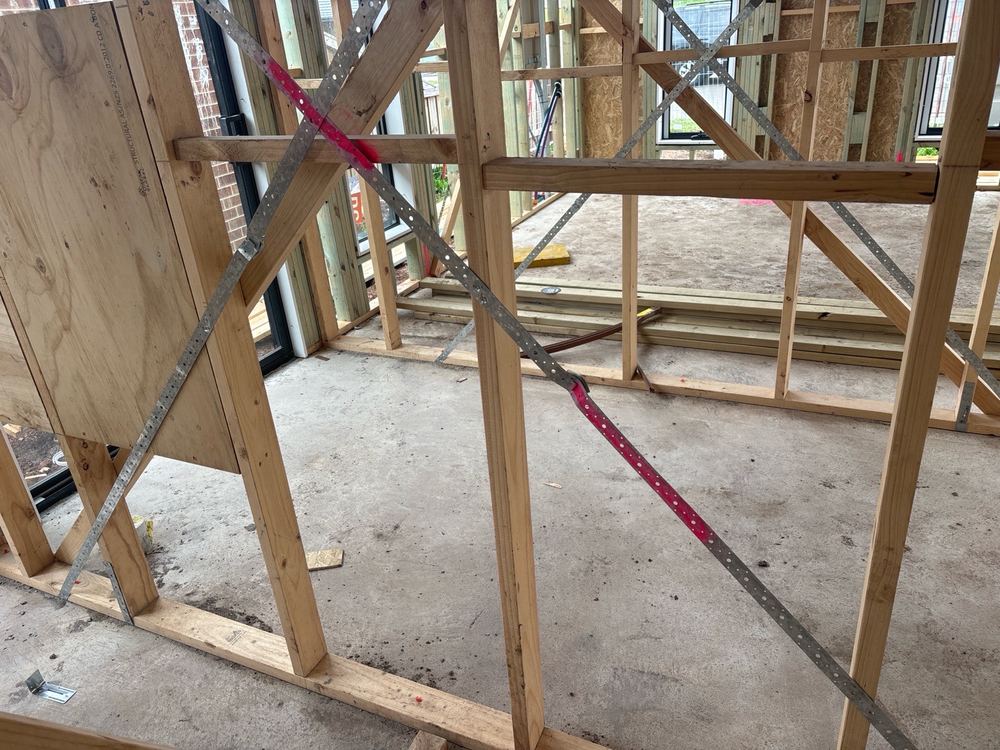 Metal strap bracing left slack, so it cannot do its job in wind, Beveridge