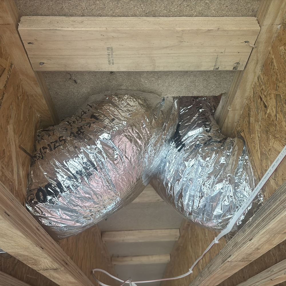 Heating ducts crimped through tight bends in the roof space, choking the airflow, found during a lock-up inspection in Beveridge