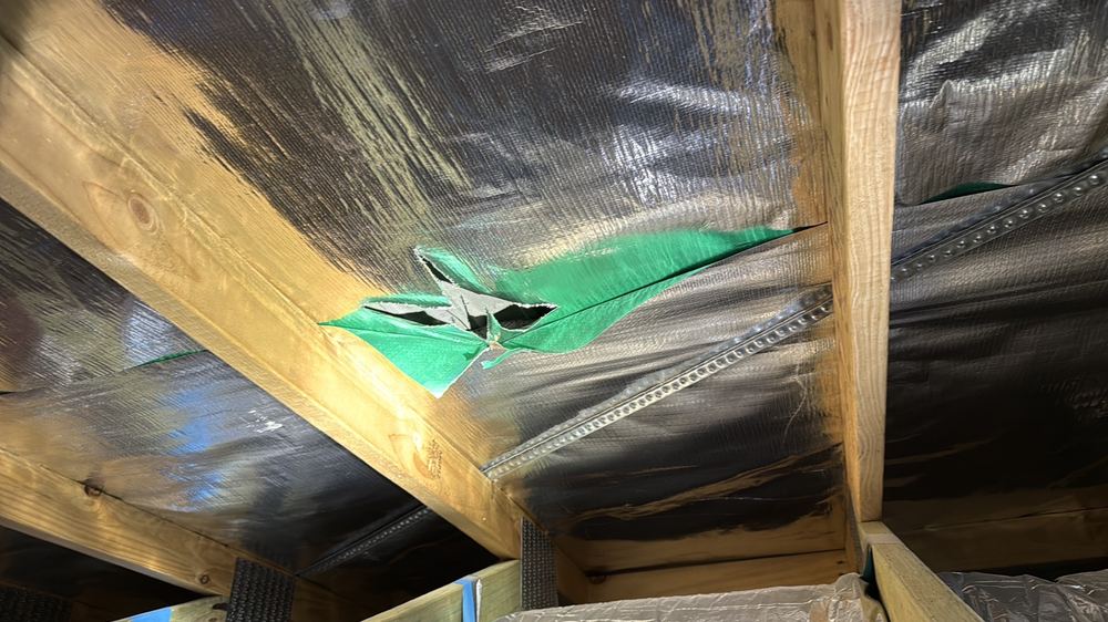 Sarking cut and torn under the roof, letting water through to the ceiling, found during a pre-handover (PCI) inspection in Beveridge